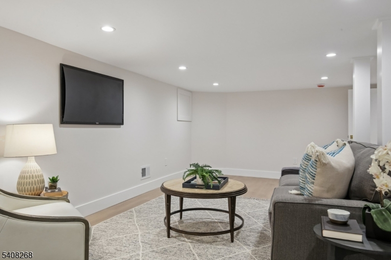 108 Baker Street Maplewood, NJ 07040 - Photo 41 of 46 a living room with furniture and a lamp