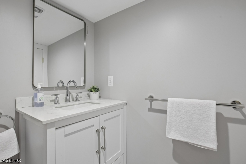 108 Baker Street Maplewood, NJ 07040 - Photo 43 of 46 a bathroom with a sink and a mirror