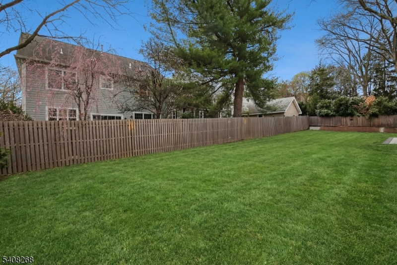 108 Baker Street Maplewood, NJ 07040 - Photo 46 of 46 a view of a backyard with large trees and wooden fence