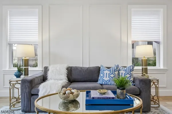 a living room with furniture and a potted plant