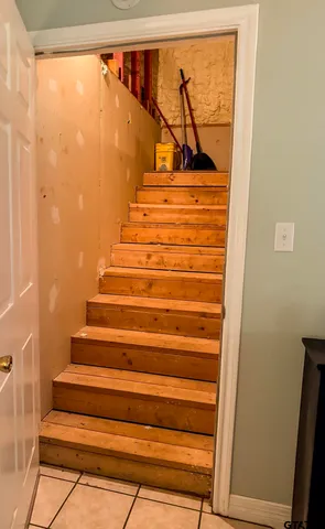 a view of deck with chairs and wooden fence