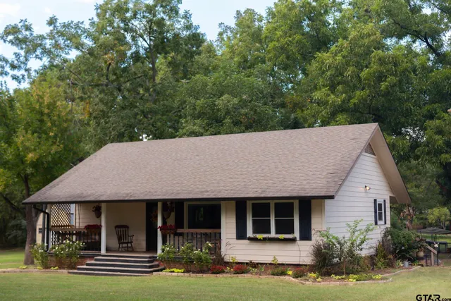 a front view of a house with a garden and plants