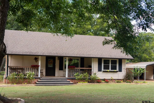 a front view of a building with trees