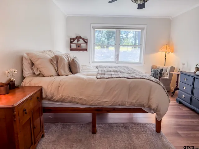 a bed sitting in a bedroom next to a window