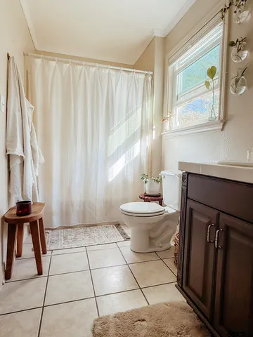 a bathroom with a toilet a sink and a mirror