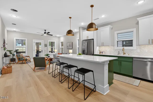 a living room with furniture a window and a chandelier