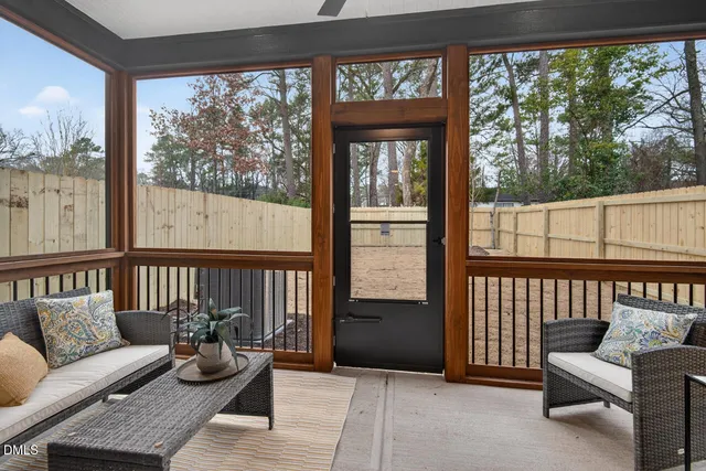 a living room with furniture and kitchen view