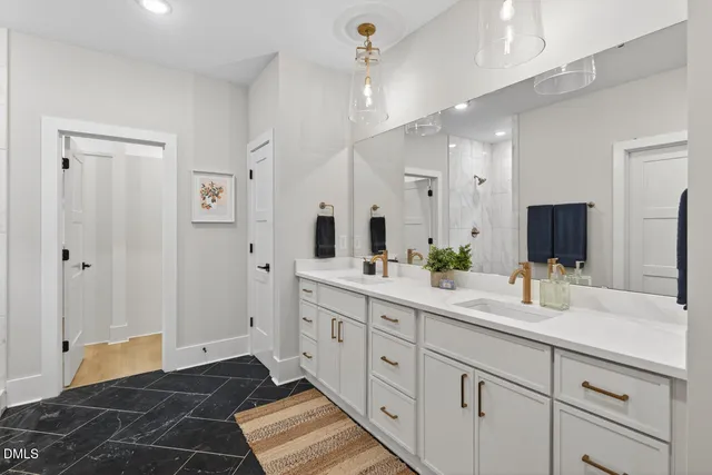 a bedroom with a large bed chandelier and a window