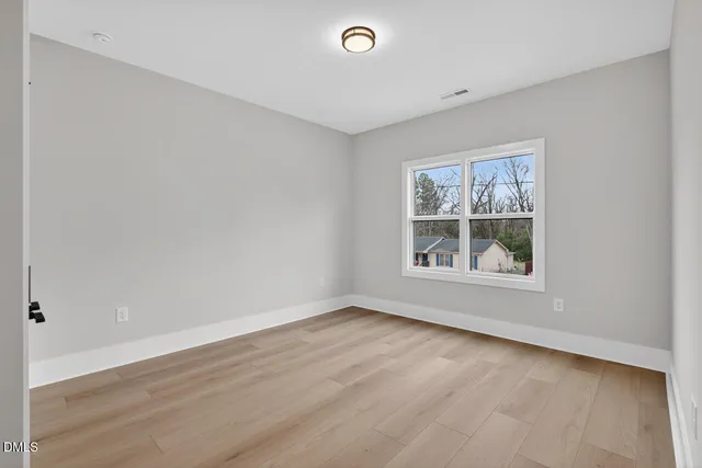 a spacious bathroom with double vanity and a mirror