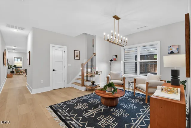 a hallway with painting and a potted plant