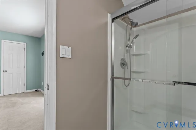 a bathroom with a glass shower door