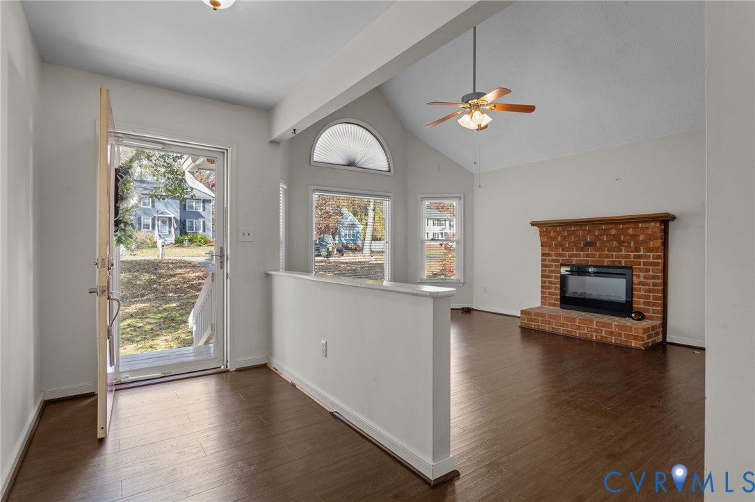14319 Key Deer Drive Midlothian, VA 23112 - Photo 3 of 42 an empty room with wooden floor a chandelier fan and windows