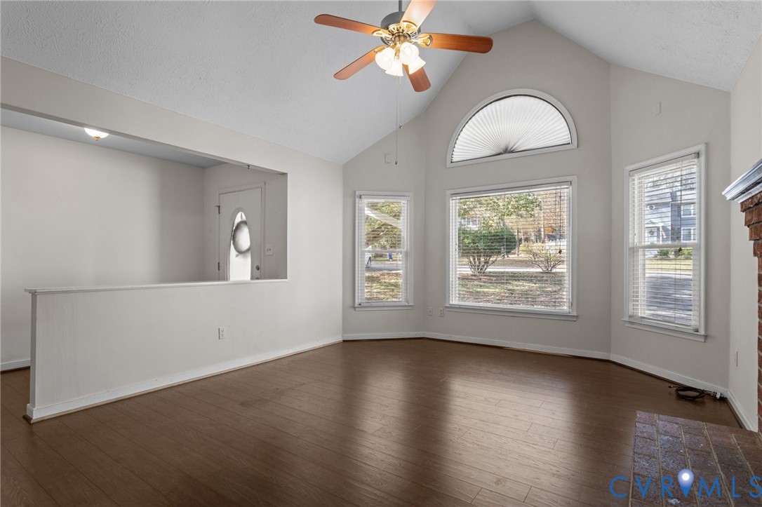 14319 Key Deer Drive Midlothian, VA 23112 - Photo 8 of 42 an empty room with wooden floor chandelier fan and windows