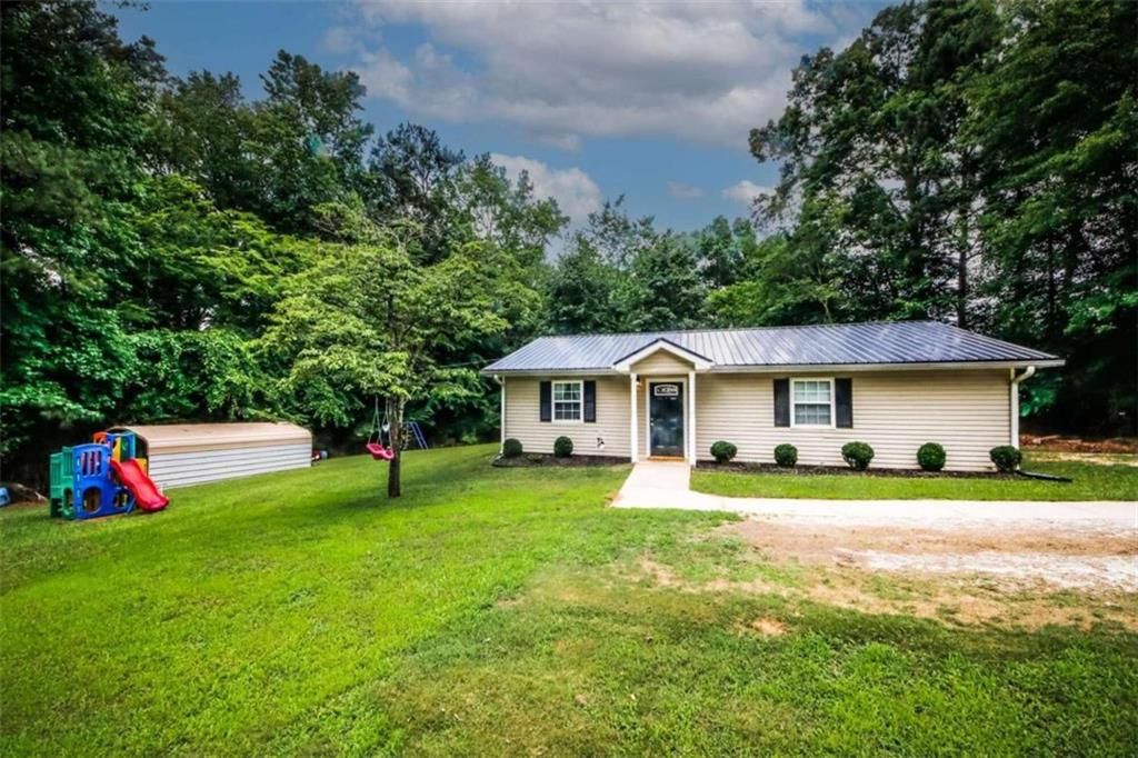 35 Rocky Ridge Court Covington, GA 30016 - Photo 1 of 1 a view of a house with a big yard and potted plants and large trees