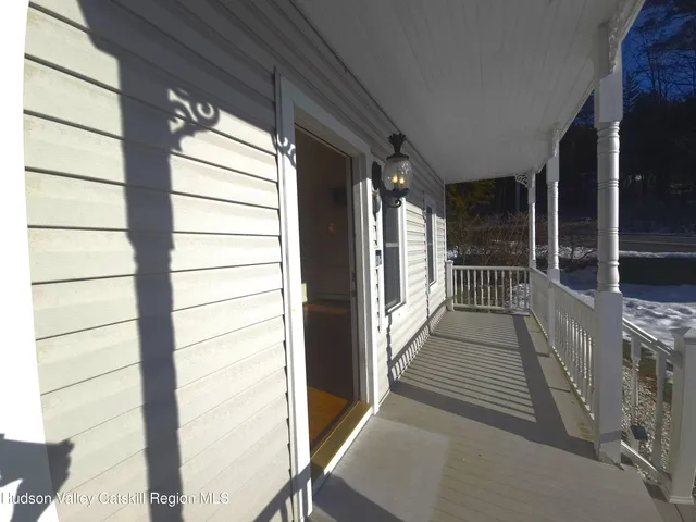 a view of a house with a large trees with wooden fence