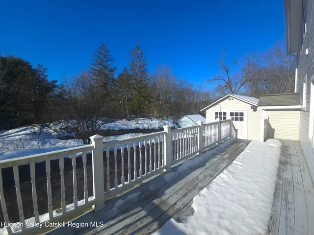 a view of a livingroom with furniture and staircase