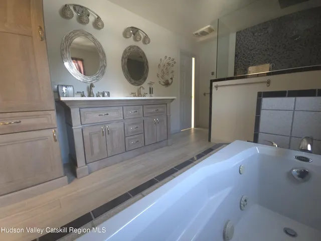 a view of a patio with table and chairs with wooden floor and plants