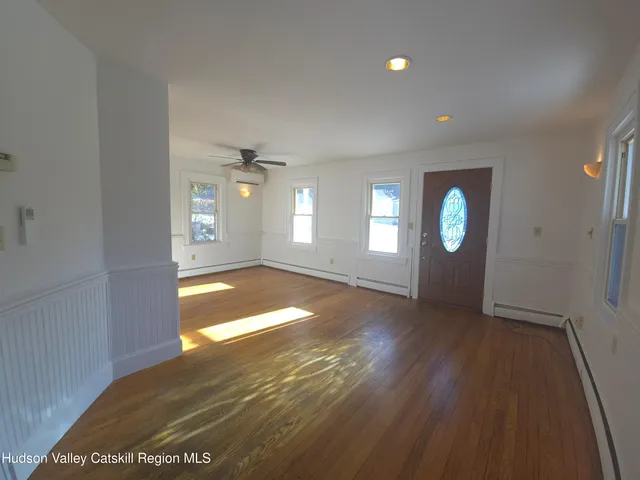 a kitchen with stainless steel appliances granite countertop a sink a stove a refrigerator cabinets and a window