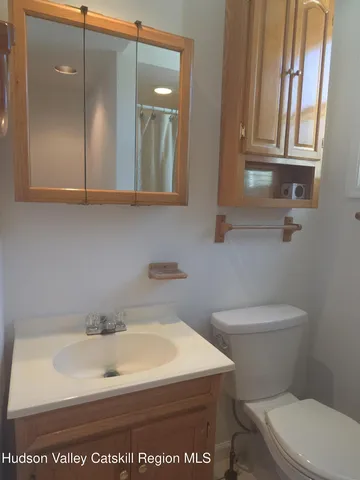 a view of a livingroom with a ceiling fan and window
