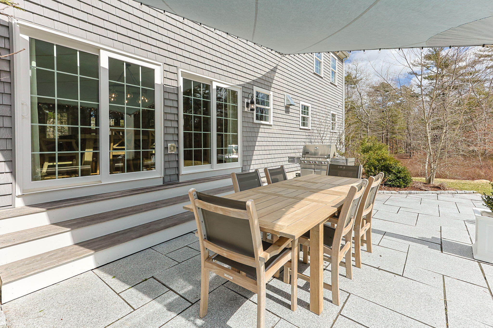 174 Cross Neck Road Marion, MA 02738 - Photo 31 of 41 a view of a patio with table and chairs with wooden floor and fence
