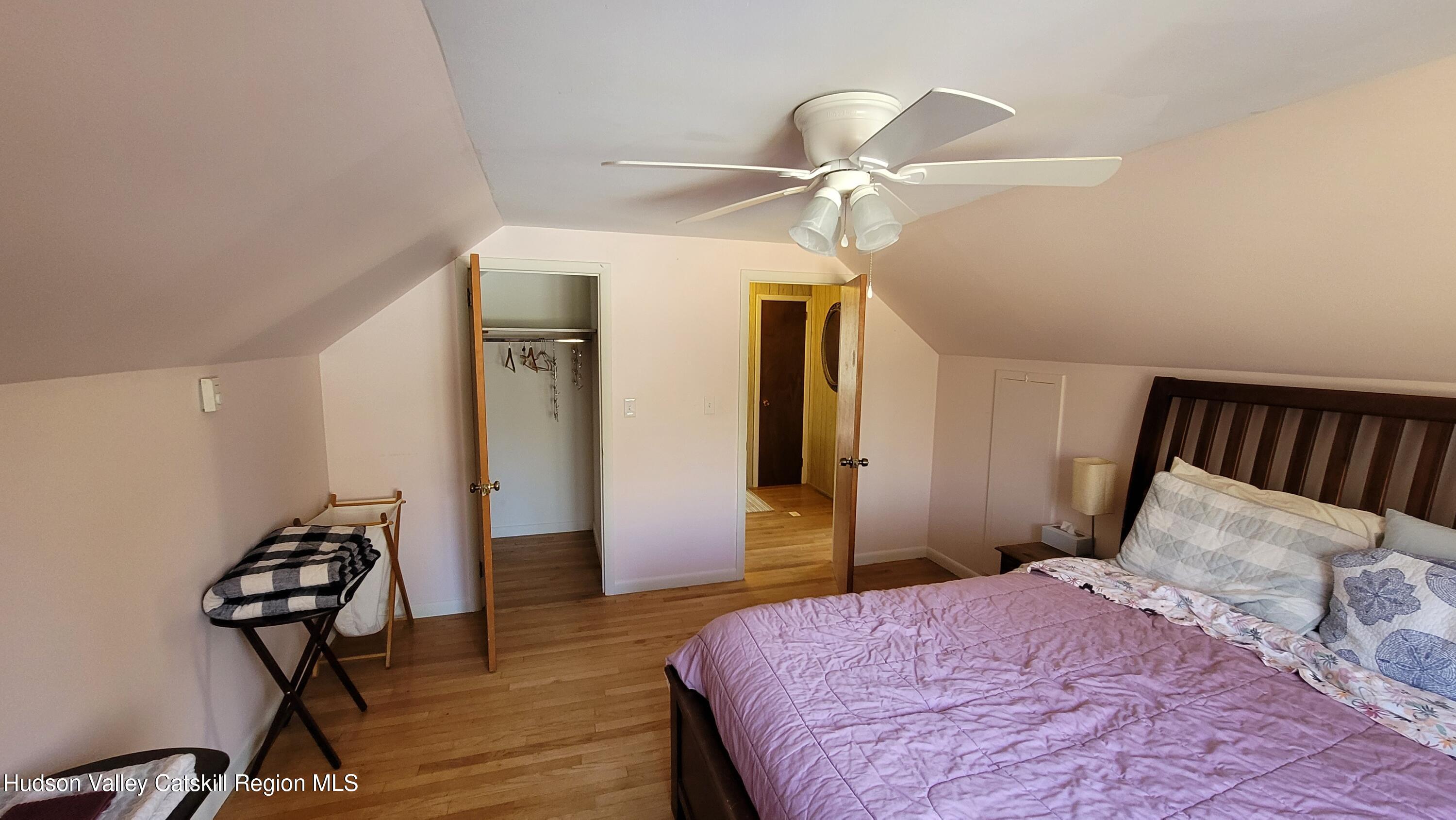 97 Ruby Road Kingston, NY 12401 - Photo 21 of 25 a bedroom with a bed and a chandelier