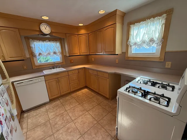 a kitchen with a cabinets a sink and a stove top oven
