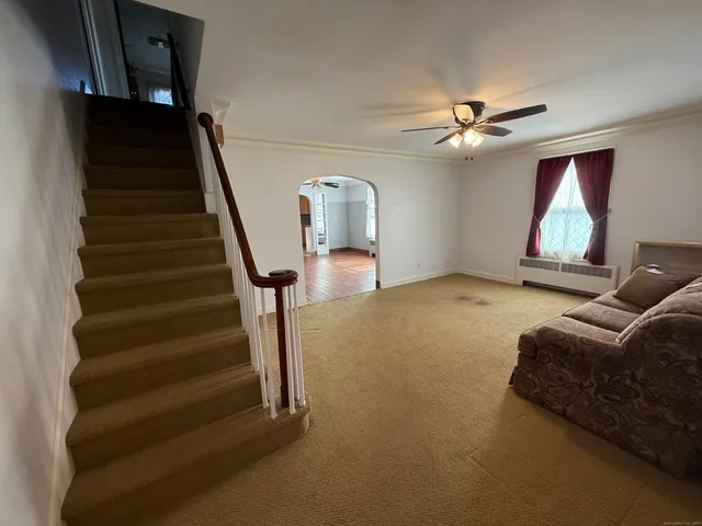 a living room with furniture and a chandelier