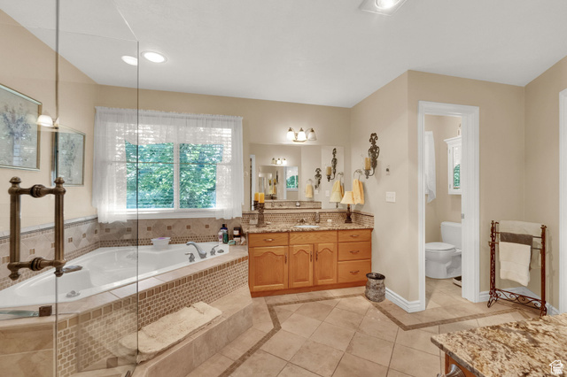 7740 Keswick Road Sandy, UT 84093 - Photo 34 of 74 Spacious bathroom featuring an oversized corner soaking tub with mosaic tile surround, a large window, and a glass-enclosed shower
