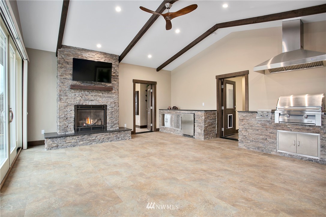 1130 West Axton Road Ferndale, WA 98248 - Photo 11 of 40 a view of a livingroom with a fireplace and chandelier