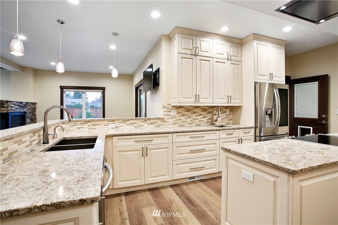 1130 West Axton Road Ferndale, WA 98248 - Photo 21 of 40 a kitchen with stainless steel appliances granite countertop a sink and cabinets