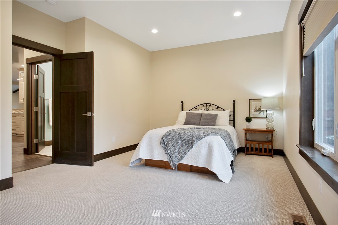 1130 West Axton Road Ferndale, WA 98248 - Photo 26 of 40 a bedroom with a bed and a large mirror