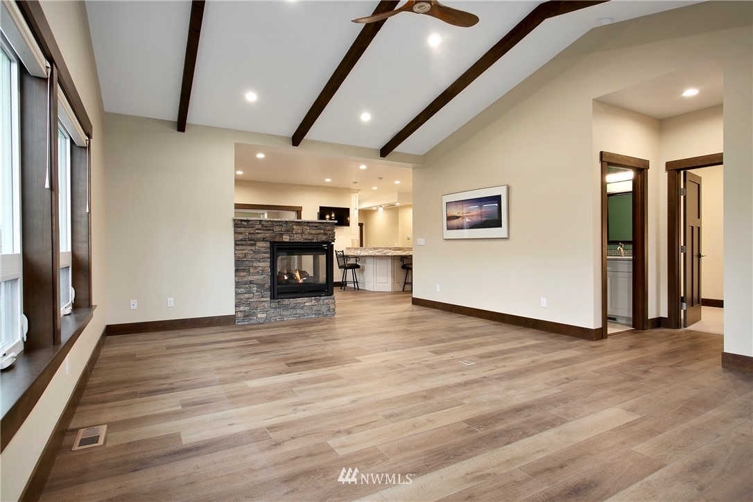 1130 West Axton Road Ferndale, WA 98248 - Photo 5 of 40 an empty room with wooden floor and furniture