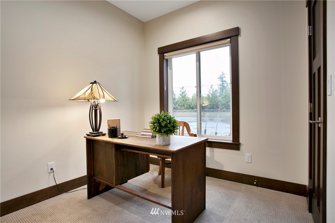 1130 West Axton Road Ferndale, WA 98248 - Photo 7 of 40 a room with a table and a potted plant