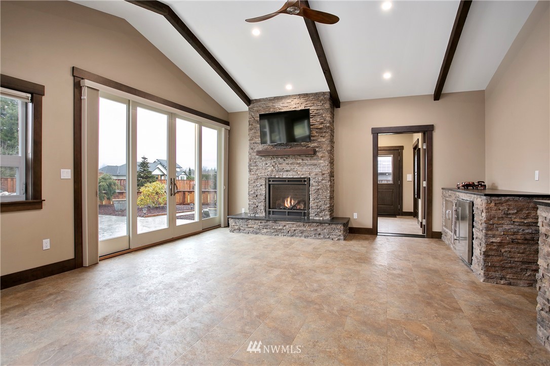 1130 West Axton Road Ferndale, WA 98248 - Photo 10 of 40 a view of empty room with fireplace and windows