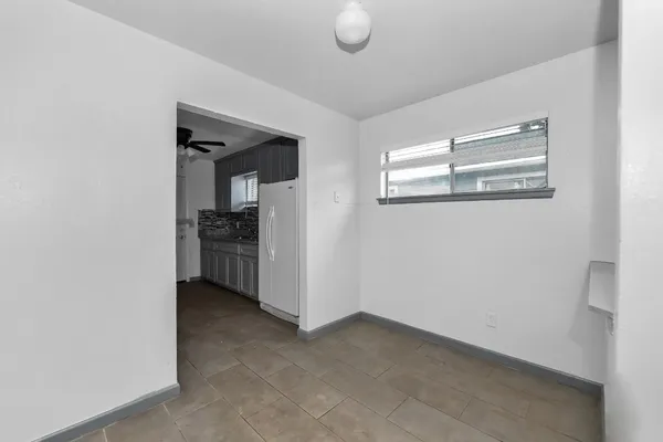 a view of an empty room with a kitchen