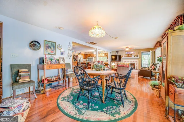 a dining room with furniture a chandelier and wooden floor