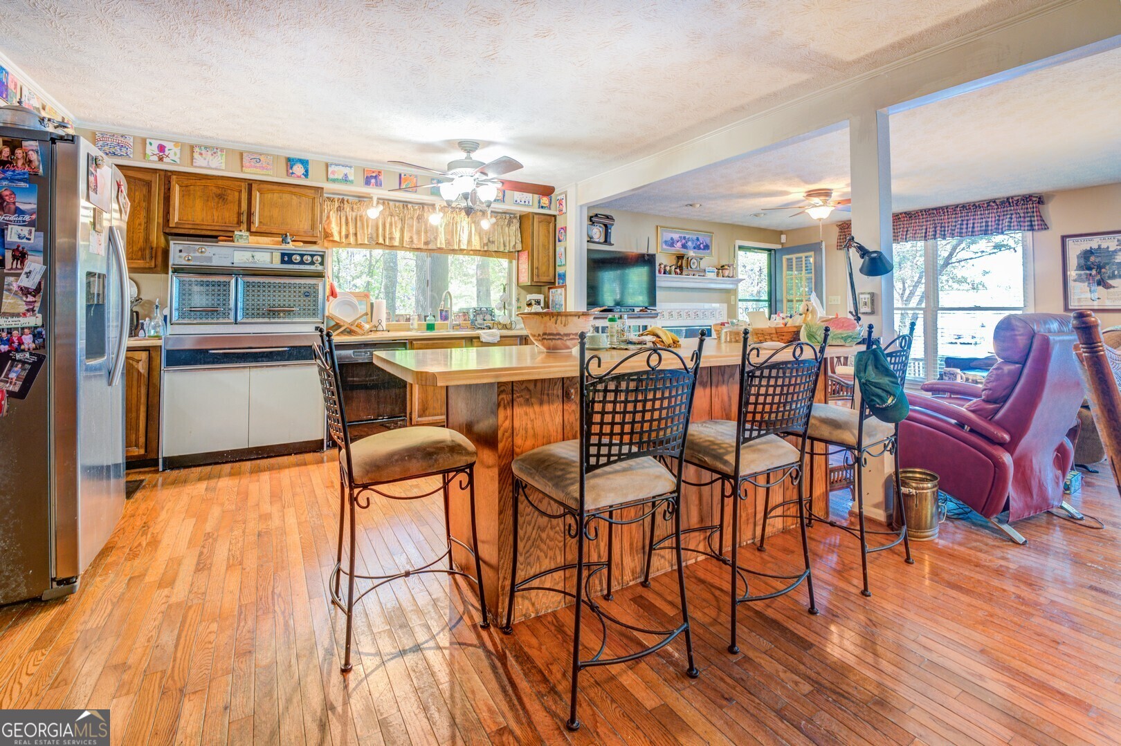 766 Raven Road Monticello, GA 31064 - Photo 24 of 59 a dining hall with stainless steel appliances granite countertop a stove and a wooden floors