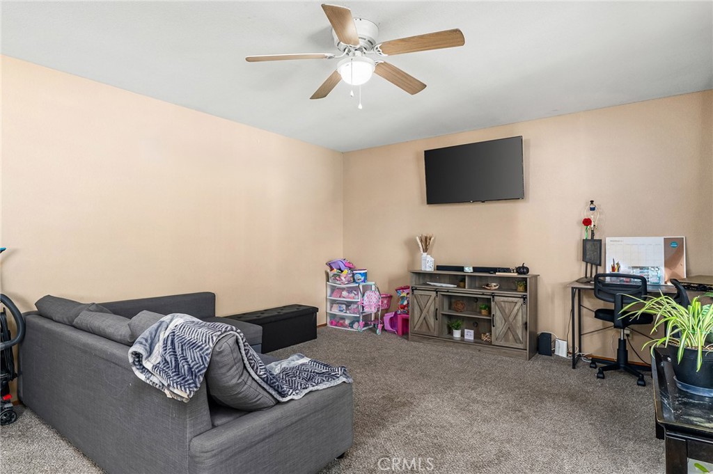 631 North Street Corning, CA 96021 - Photo 12 of 39 a living room with furniture and a flat screen tv