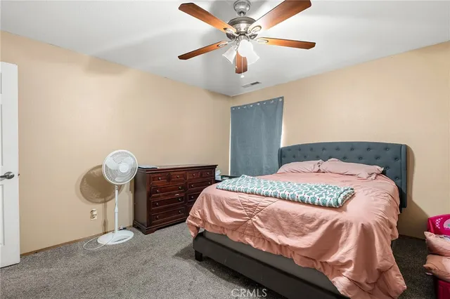 a bedroom with a bed and chandelier