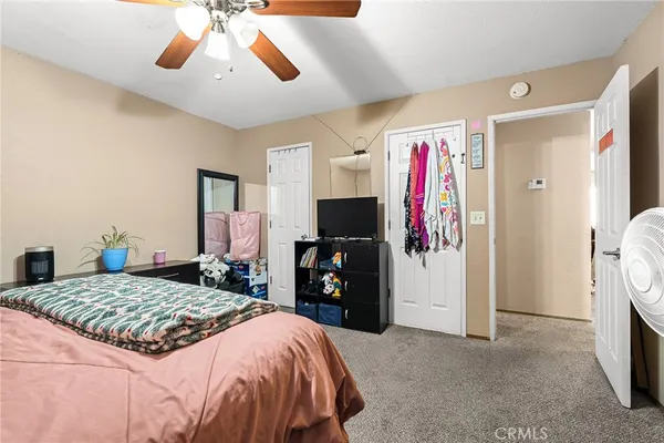a bedroom with a bed and a flat tv screen