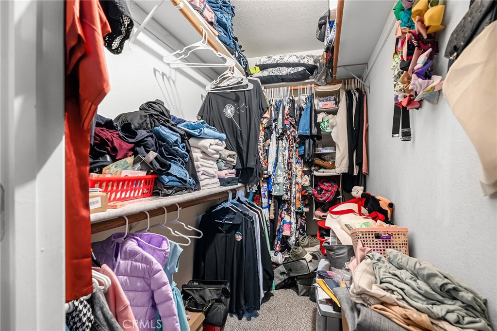 631 North Street Corning, CA 96021 - Photo 19 of 39 a view of walk in closet with clothes and shoes