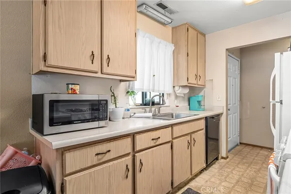 a kitchen with stainless steel appliances white cabinets and a sink