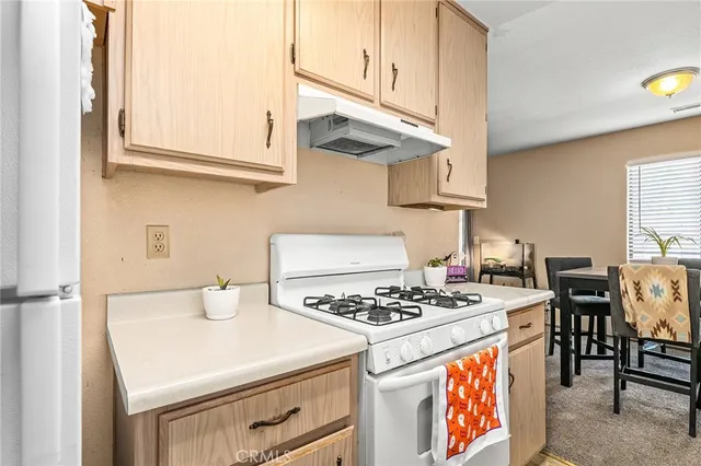 a kitchen with stainless steel appliances a stove a sink and a refrigerator