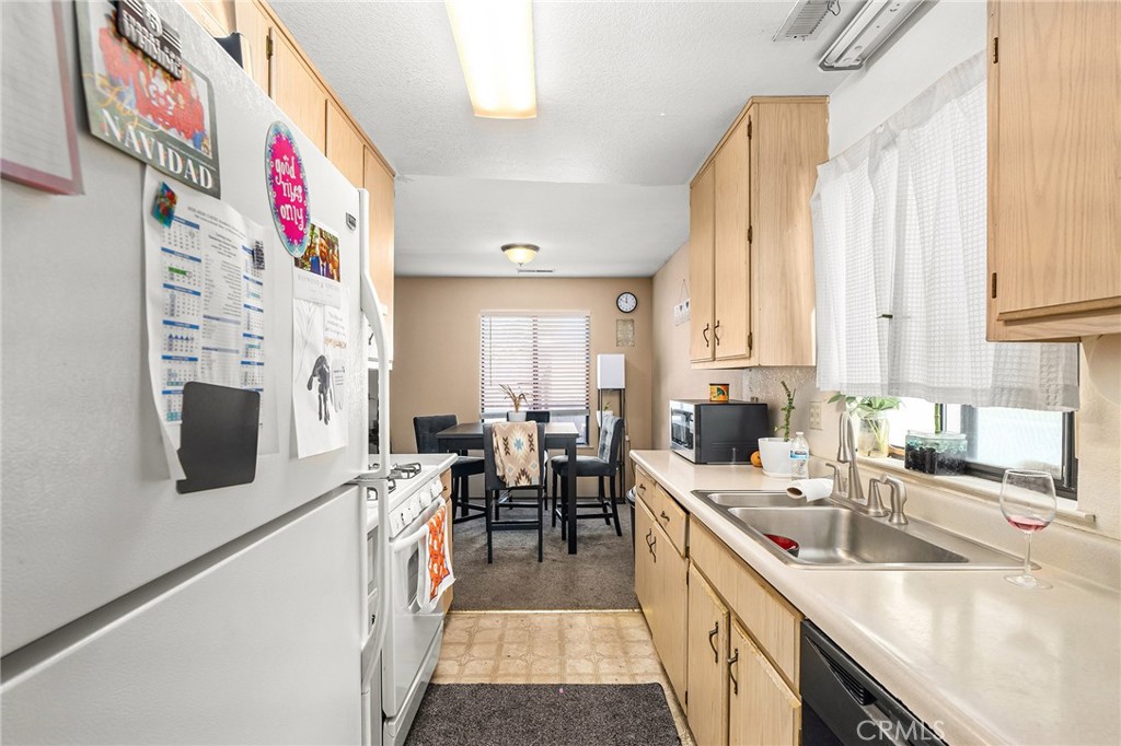 631 North Street Corning, CA 96021 - Photo 6 of 39 a kitchen that has a lot of cabinets a sink and a stove in it