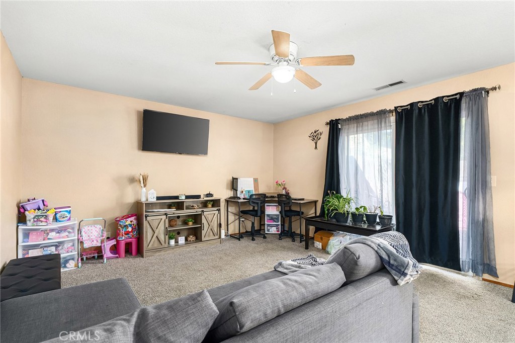 631 North Street Corning, CA 96021 - Photo 10 of 39 a living room with furniture and a flat screen tv