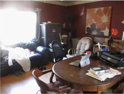 a living room with furniture and a mirror