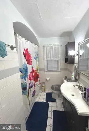 a bathroom with a sink mirror and vanity