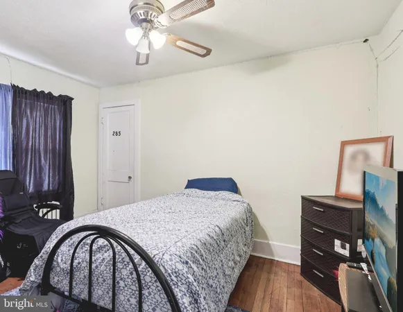 a bedroom with a bed and a desk