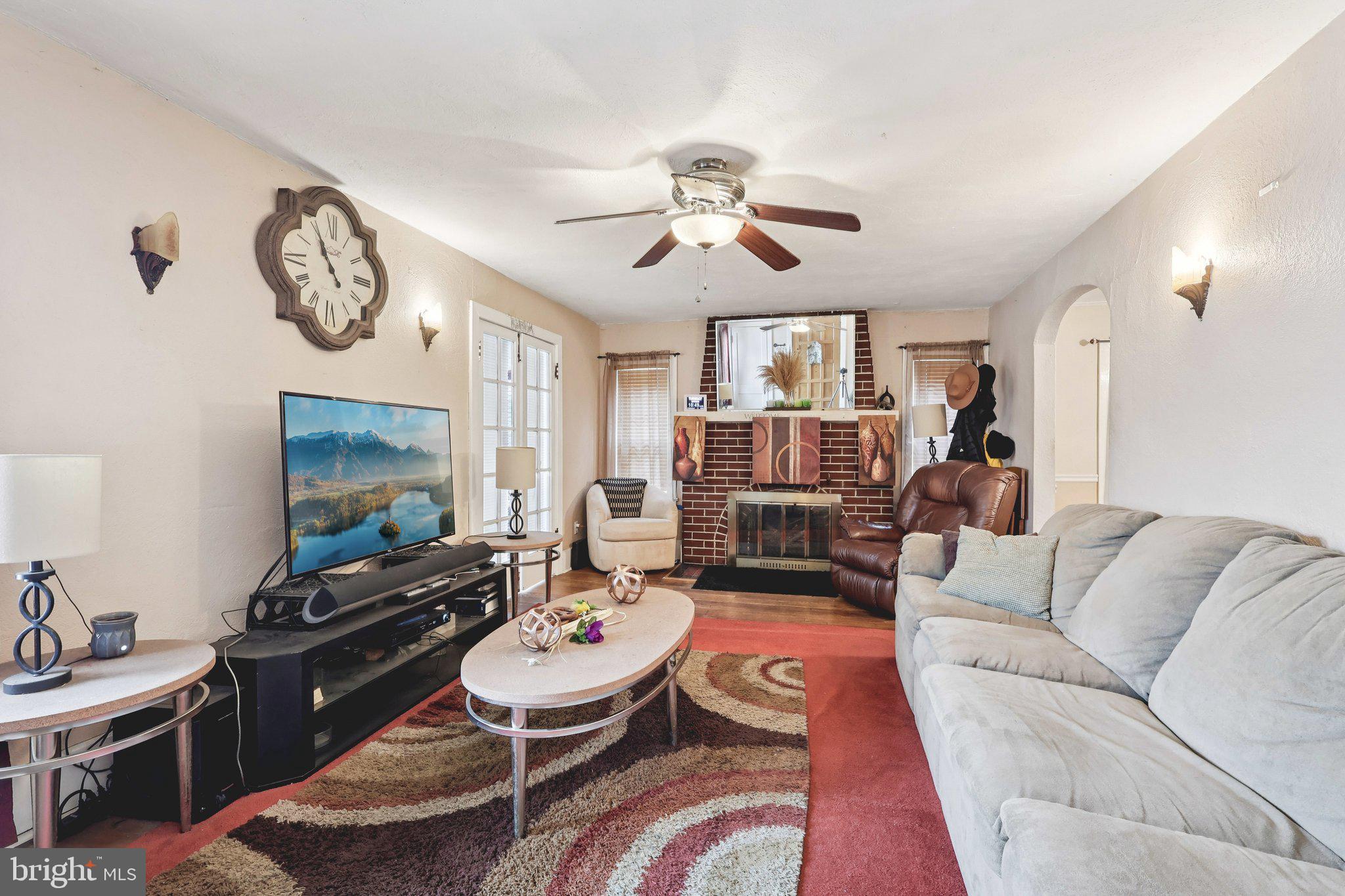 285 Watson Avenue Hamilton, NJ 08610 - Photo 4 of 18 a living room with furniture a clock on wall and a flat screen tv
