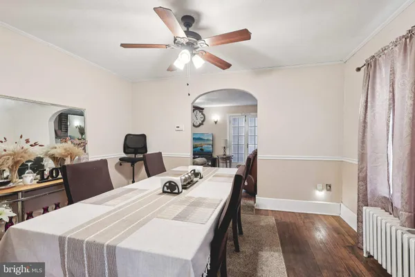 a view of a dining room with furniture and a chandelier fan